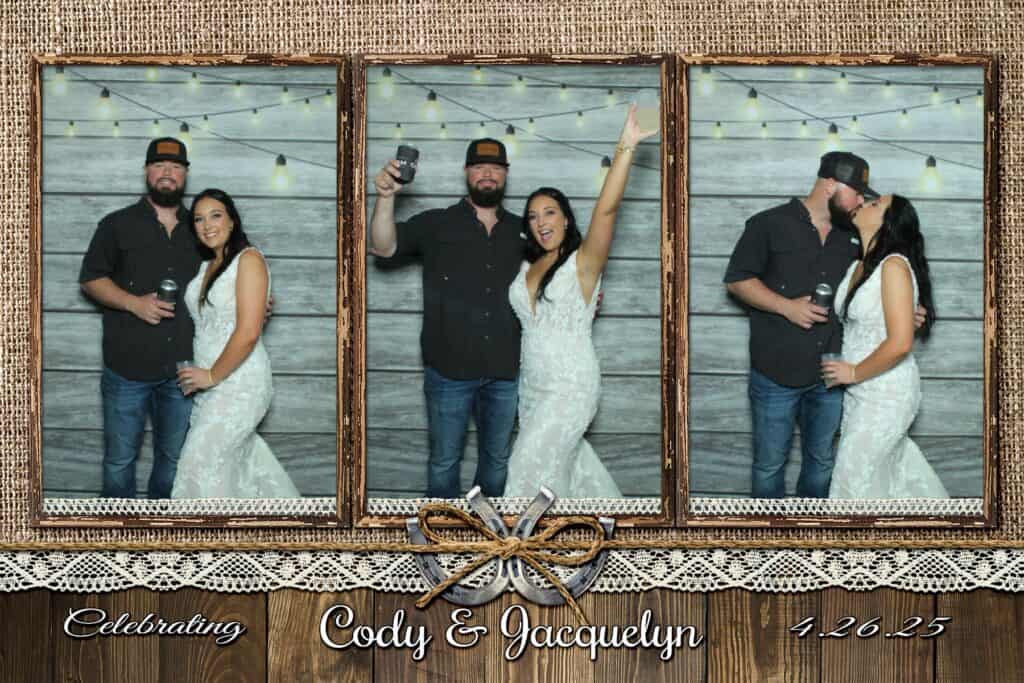 Cody and Jacquelyn posing in the photo booth at their wedding at The Barn at Southern Oaks