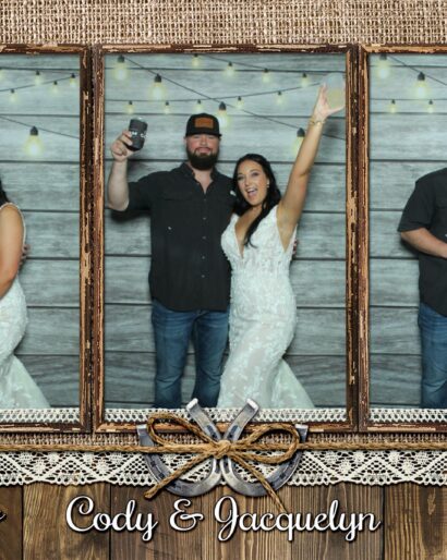 Cody and Jacquelyn posing in the photo booth at their wedding at The Barn at Southern Oaks