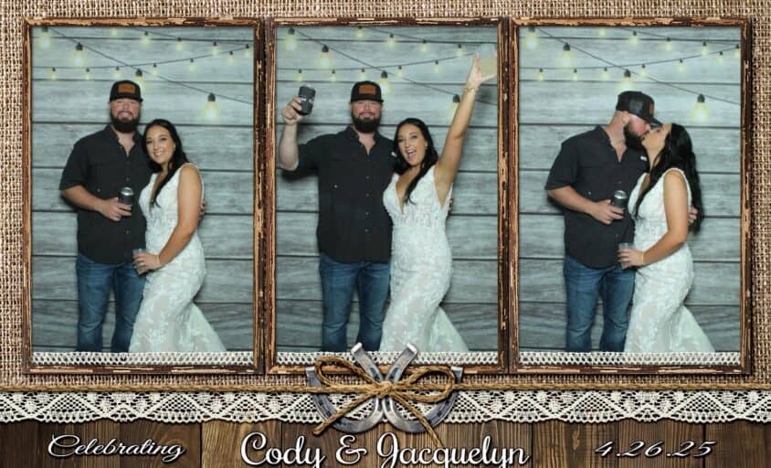 Cody and Jacquelyn posing in the photo booth at their wedding at The Barn at Southern Oaks