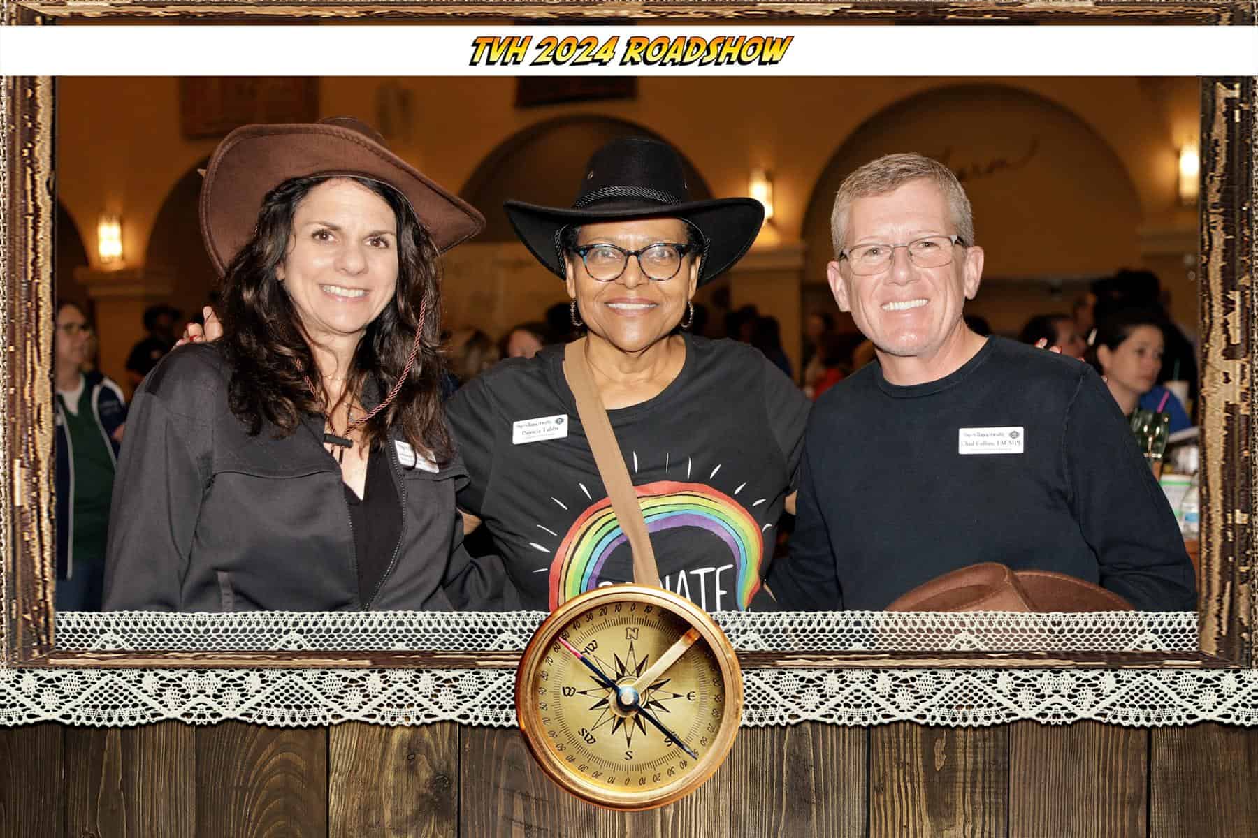 Smart event photography portrait of three guests with a TVH 2024 Roadshow frame