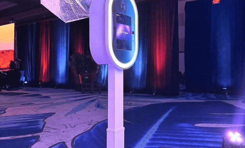 Experience Booth Pro photo booth with an illuminated screen at an indoor event